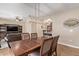 Dining room features a decorative light fixture above a wood table with seating for six at 19700 N 76Th St # 2101, Scottsdale, AZ 85255
