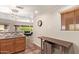 Kitchen nook with tile floor, stainless steel trash bin, and view into the living room at 19700 N 76Th St # 2101, Scottsdale, AZ 85255