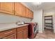 This functional laundry room features cabinets, a sink, and a red washer and dryer set at 19700 N 76Th St # 2101, Scottsdale, AZ 85255