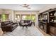 The living room has wood floors, couches, and views of the desert landscaping outside at 19700 N 76Th St # 2101, Scottsdale, AZ 85255