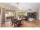Open-concept living space featuring dining area, sliding glass door, and living room with wood-look flooring at 19700 N 76Th St # 2101, Scottsdale, AZ 85255