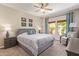Comfortable bedroom with large windows, ceiling fan, and neutral decor at 19700 N 76Th St # 2101, Scottsdale, AZ 85255