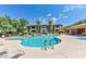 Inviting community pool with ample lounge seating, lush greenery, and clear blue water for relaxation at 19700 N 76Th St # 2101, Scottsdale, AZ 85255