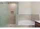 Elegant bathroom showcasing a large tub and separate shower with tiled walls at 19700 N 76Th St # 2169, Scottsdale, AZ 85255