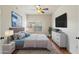 Comfortable bedroom featuring modern decor, a ceiling fan, and ample closet space at 19700 N 76Th St # 2169, Scottsdale, AZ 85255