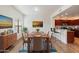 Dining room with wood table, hardwood floors, adjacent bar, and lots of natural light at 19700 N 76Th St # 2169, Scottsdale, AZ 85255
