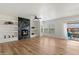 Living room with open floor plan, fireplace, hardwood floors, and access to a balcony at 19700 N 76Th St # 2169, Scottsdale, AZ 85255