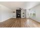Open-concept living room with stylish fireplace, hardwood floors, and lots of natural light at 19700 N 76Th St # 2169, Scottsdale, AZ 85255
