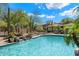 Resort-style pool area with waterfall feature and lush desert landscaping under a bright blue sky at 19700 N 76Th St # 2169, Scottsdale, AZ 85255