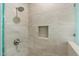 Elegant tiled shower with rain shower head and built-in niche offers a spa-like experience at 19700 N 76Th St # 2169, Scottsdale, AZ 85255