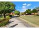 Scenic paved walkway winds through lush landscaping and manicured lawns and flowering bushes at 19700 N 76Th St # 2169, Scottsdale, AZ 85255