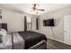 Bedroom with wood-look floors, a ceiling fan, a television, and lots of natural light at 19777 N 76Th St # 1131, Scottsdale, AZ 85255