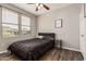 Comfortable bedroom with wood-look floors, a ceiling fan, and a bright, natural light at 19777 N 76Th St # 1131, Scottsdale, AZ 85255