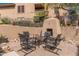 Private outdoor patio with fireplace and table with chairs, perfect for social gatherings and warm evenings at 19777 N 76Th St # 1131, Scottsdale, AZ 85255