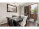 Elegant dining room with a modern chandelier and black dining table, bathed in natural light at 19777 N 76Th St # 1131, Scottsdale, AZ 85255
