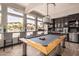This game room includes a pool table, bar seating, and a kitchenette for endless entertainment at 19777 N 76Th St # 1131, Scottsdale, AZ 85255