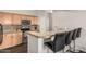 Well-equipped kitchen featuring stainless steel appliances, granite countertops, and bar seating at 19777 N 76Th St # 1131, Scottsdale, AZ 85255