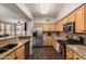 Charming kitchen featuring granite countertops, wood cabinets, and stainless steel appliances at 19777 N 76Th St # 1131, Scottsdale, AZ 85255