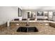 Granite countertop with double sink and mosaic tile backsplash adds stylish touches to this kitchen area at 19777 N 76Th St # 1131, Scottsdale, AZ 85255