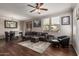 Inviting living room featuring a plush gray sectional, ceiling fan, and dark wood floors at 19777 N 76Th St # 1131, Scottsdale, AZ 85255