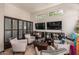 This cozy lounge area features ample seating, a bookshelf, and natural light from the large windows at 19777 N 76Th St # 1131, Scottsdale, AZ 85255