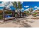 Relaxing pool area featuring two cabanas with privacy curtains, multiple lounge chairs, and lush landscaping at 19777 N 76Th St # 1131, Scottsdale, AZ 85255