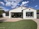 Backyard featuring artificial grass, a covered patio, and a stucco fence at 20525 W Hamilton St, Buckeye, AZ 85396