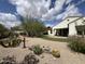 Expansive backyard showcasing desert landscaping, mature trees, and a covered patio at 20525 W Hamilton St, Buckeye, AZ 85396