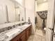 Bathroom featuring double sinks, granite countertops, tiled floors, and a separate toilet and shower area at 20525 W Hamilton St, Buckeye, AZ 85396