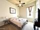 Cozy bedroom with carpet, ceiling fan, ample lighting, and a decorative bedspread at 20525 W Hamilton St, Buckeye, AZ 85396