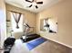 Exercise room featuring a ceiling fan, window, and a treadmill in front of a large mirror at 20525 W Hamilton St, Buckeye, AZ 85396