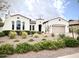 Charming white single-story home with a well-manicured desert landscape, arched windows, and a two-car garage at 20525 W Hamilton St, Buckeye, AZ 85396