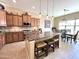 The kitchen features stainless steel appliances, a large island with seating, and an adjacent dining area at 20525 W Hamilton St, Buckeye, AZ 85396