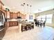 Bright kitchen with stainless steel appliances, granite countertops, island seating, and wood cabinets at 20525 W Hamilton St, Buckeye, AZ 85396