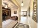 View of an open floor plan with a tile entryway, brown leather sofa, and built in shelving unit at 20525 W Hamilton St, Buckeye, AZ 85396