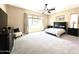 Spacious main bedroom with a king bed, carpet flooring, ceiling fan, and lots of natural light at 20525 W Hamilton St, Buckeye, AZ 85396
