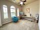 Bright studio room with arched windows, an easel with artwork, and neutral walls at 20525 W Hamilton St, Buckeye, AZ 85396