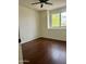 Spacious bedroom features hardwood floors, window, ceiling fan, and plenty of natural light at 2074 N 109Th N Ave, Avondale, AZ 85392
