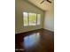 Bright bedroom with hardwood floors and a window showcasing natural light and outdoor views at 2074 N 109Th N Ave, Avondale, AZ 85392