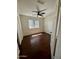 Bedroom showcasing hardwood floors, a window, closet doors, and a ceiling fan at 2074 N 109Th N Ave, Avondale, AZ 85392