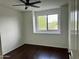 Bright bedroom features a ceiling fan, hardwood floors, and a window with views at 2074 N 109Th N Ave, Avondale, AZ 85392