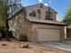 Inviting two-story home featuring a neutral-colored exterior, tile roof and attached two car garage at 2074 N 109Th N Ave, Avondale, AZ 85392