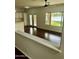 Bright living space with hardwood floors, white cabinets, natural light, and a backyard view at 2074 N 109Th N Ave, Avondale, AZ 85392