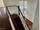 Staircase with wood stairs and white railings leading to the upper level of this bright home at 2074 N 109Th N Ave, Avondale, AZ 85392
