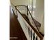 Interior shot of a home staircase with hardwood floors, wood handrail, and bright light at 2074 N 109Th N Ave, Avondale, AZ 85392