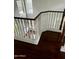A staircase showcasing dark hardwood floors, white railings, and abundant natural light from nearby windows at 2074 N 109Th N Ave, Avondale, AZ 85392