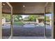 Inviting backyard featuring a covered patio, swimming pool, lush lawn, and mature trees at 2106 E La Vieve Ln, Tempe, AZ 85284