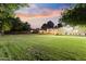 Lush backyard featuring a well-maintained lawn, mature trees, and ample space for recreation and relaxation at 2106 E La Vieve Ln, Tempe, AZ 85284