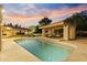 Beautiful backyard pool with covered seating area and lush landscaping, perfect for relaxation and entertaining at 2106 E La Vieve Ln, Tempe, AZ 85284