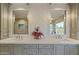Close-up of bathroom with double vanity, decorative wall tiles, and decorative mirrors at 2106 E La Vieve Ln, Tempe, AZ 85284